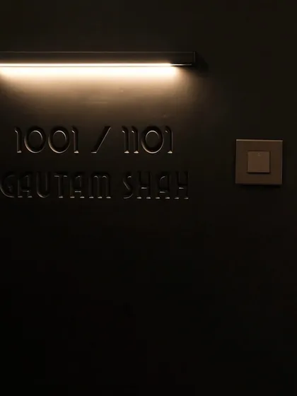 The engraved names and flushed wall light on the main door are subtle details that add a layer of personalization and sophistication. It’s these small touches that make a design feel truly bespoke.