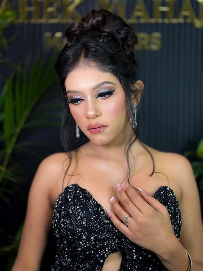 Another beautiful shot of the model in the black sequined dress, showcasing her elegant updo and stunning makeup.