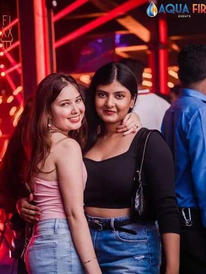 Two friends smiling for the camera during a great night at The Fixx.