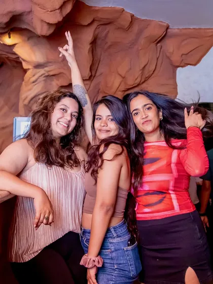 Friends posing and having a great time at our rooftop party. It's the perfect midweek escape.