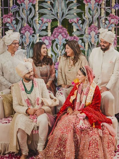 A beautiful family portrait against the stunning floral backdrop of the mandap. We ensure there are moments for not just the couple, but for their families to come together.
