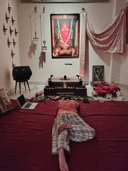 Another moment of deep surrender before the Devi. The red carpet signifies her vibrant, earthy energy, creating a consecrated ground for our practices.