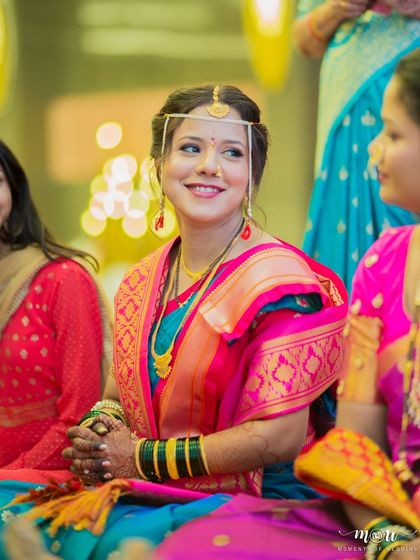 A candid moment of a smiling bride during her ceremony. The makeup is subtle and enhances her natural happiness, making her look effortlessly beautiful.