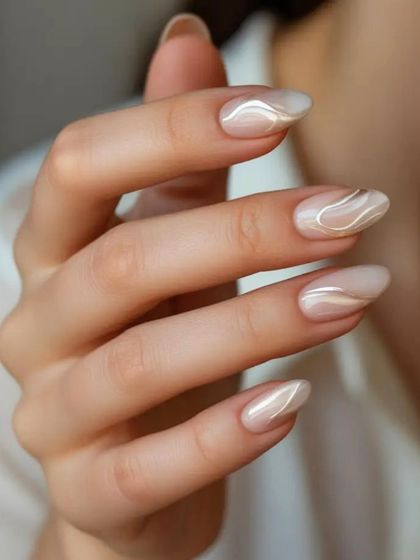 For a modern and artistic touch, I create designs like these pearlescent nails with delicate, shimmering swirls. This style adds a unique element while remaining elegant and understated.