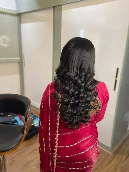 Soft, cascading waves for a simple yet elegant look. This hairstyle is perfect for complementing a beautiful saree without being overpowering.