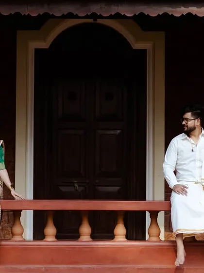 A serene portrait of a couple in traditional South Indian attire on the porch of a classic home. This showcases my ability to capture culturally specific and elegant pre-wedding themes.