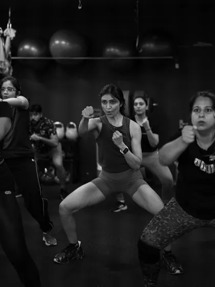 Intensity and focus captured during a Strong by Zumba class. The powerful stances and synchronized movements show how this workout builds both physical and mental toughness.
