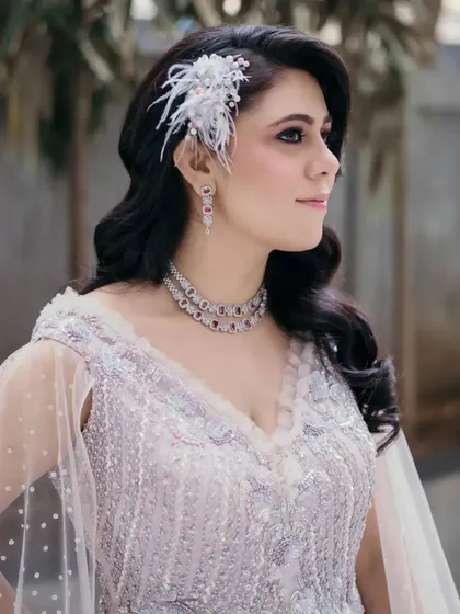 A stunning shot of the client in her full evening attire. The side-swept waves perfectly complement the neckline of her gown and her diamond jewelry.