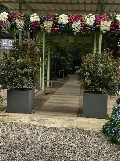 We designed this stunning wedding entrance to welcome guests. The decor features a large floral arch and a custom-made peacock sculpture, meticulously crafted from blue, purple, and green flowers, setting a luxurious tone for the event.