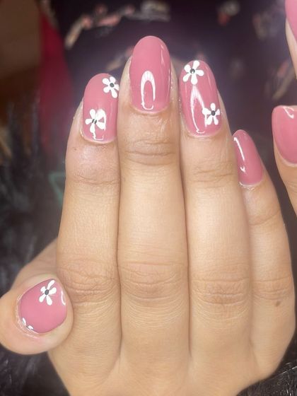A lovely dusty rose manicure with simple, hand-painted white flowers.