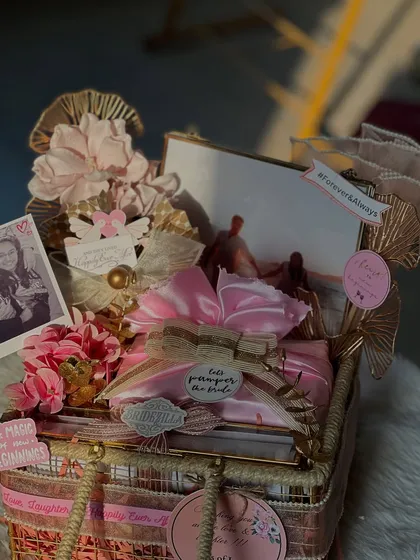 A stunning hamper from "The Bride Edit" collection. This one is all about pampering, with a beautiful mix of personalized items and keepsakes wrapped in soft pink and gold tones.