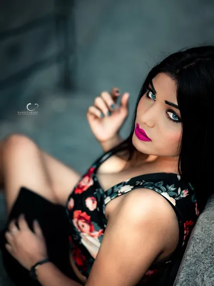 A high-angle shot that creates an intimate and engaging perspective. Her striking eyes are the focal point of this stunning portrait.