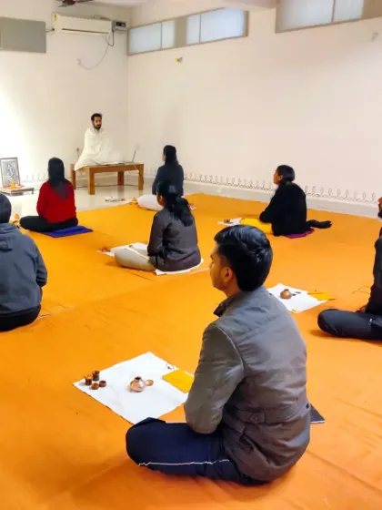 A view of the Bhuta Shuddhi class, with the teacher guiding the small group through the process.