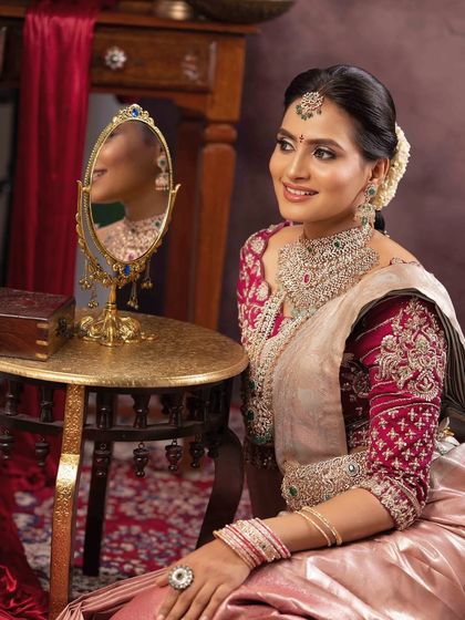 A beautiful candid moment showing the bride's reflection. The makeup is designed to look perfect from all angles, ensuring she is always ready for a picture.