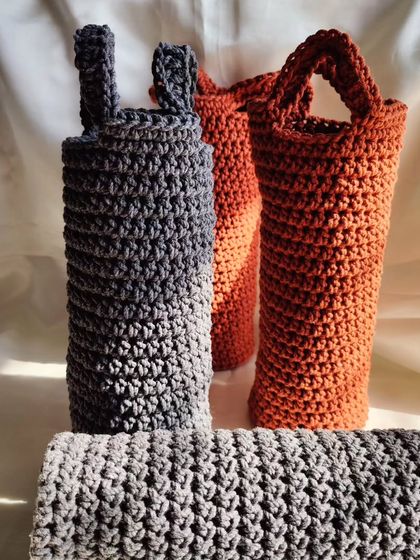 These handmade crochet water bottle covers are a stylish way to carry your bottle. They can be made with a strap so you can go hands-free.