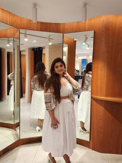 The multi-mirror reflection gives a 360-degree view of this modern ethnic ensemble, perfect for a daytime celebration.