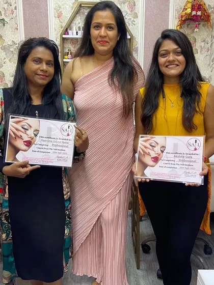 Two of my students celebrating their graduation together after completing the professional nail course.