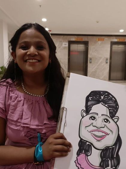 A student in a lovely party dress with her portrait.