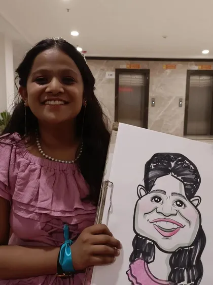 A student in a lovely party dress with her portrait.