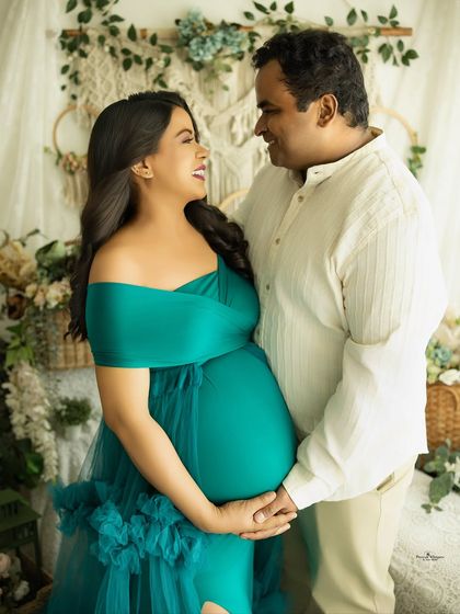 A joyful and candid moment between a couple expecting twins. Their shared laughter and loving gaze make this a truly special memory.