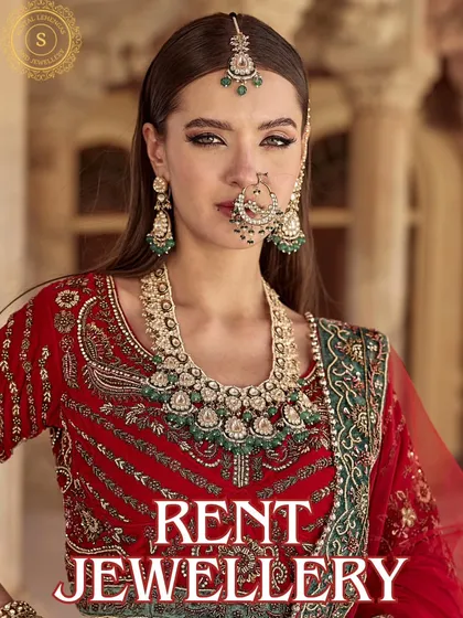Dazzle in our Kundan jewellery to get that regal feeling. This model pairs a heavy green and red bridal set with a traditional red lehenga, a classic combination you can rent.
