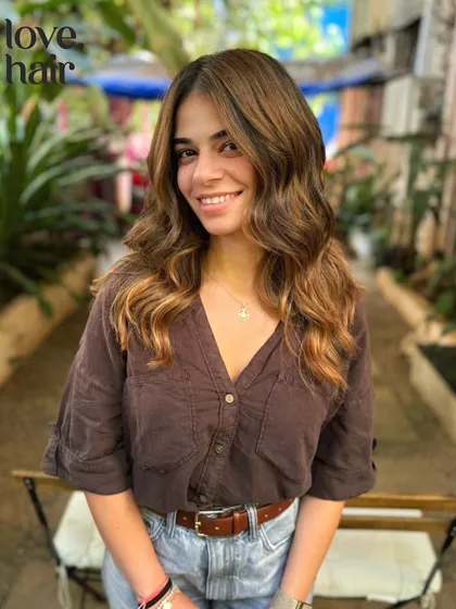 The client smiling with her new molten lava hair, a perfect look for making a statement.