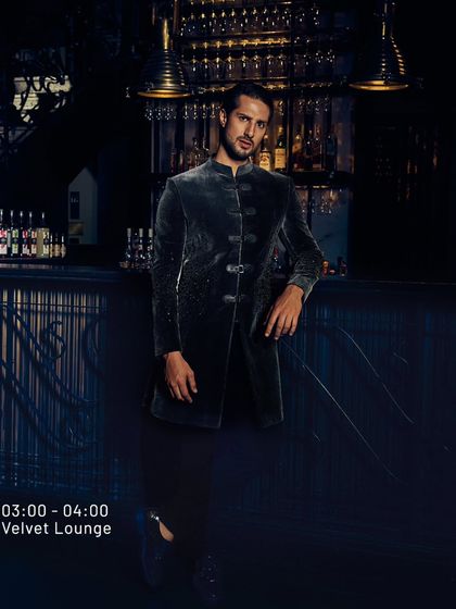 A night where style and mood collide. This velvet bandhgala, seen here in a lounge setting, is for the man who lets his outfit be the statement.