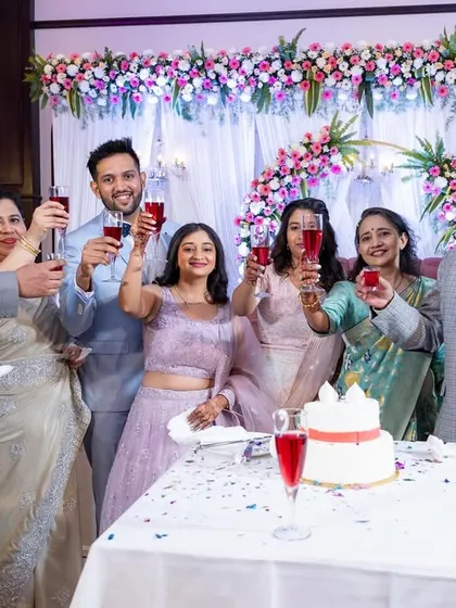 A toast to the happy couple! The whole family raises a glass to celebrate the newlyweds during their reception.