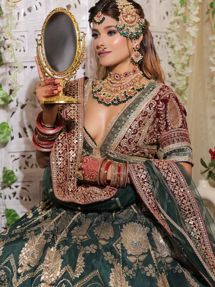 A set of three images of a bride in a green and maroon velvet lehenga. These shots capture the regal essence and are perfect for a traditional bridal lookbook.