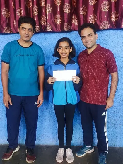Hrithika Madhur with her coaches after her bronze medal win, showcasing the supportive training environment at our academy.