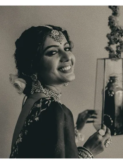 A candid moment of joy. The bride's genuine smile brings a beautiful warmth to this otherwise formal and regal look, reminding us that the person wearing the clothes is what truly matters.