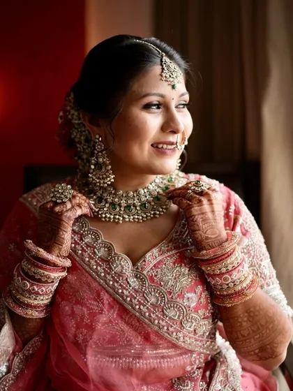 A candid moment of bridal joy. Her soft glam makeup with a subtle shimmer on the eyes ensures she looks radiant from every angle.