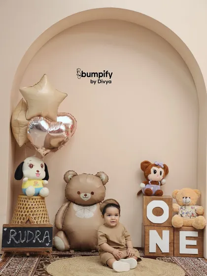 A quiet moment during his first birthday shoot. Seated amongst his teddy bear friends, this little boy looks so sweet and thoughtful.
