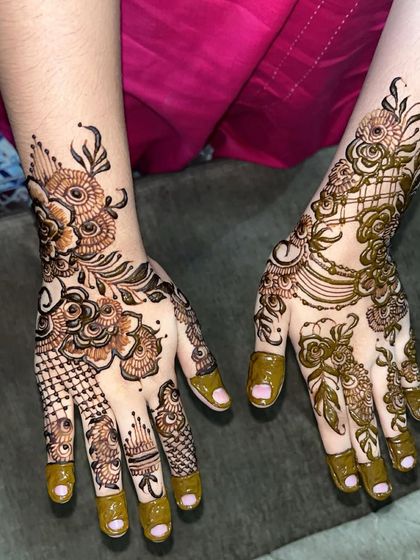 A modern Arabic design with a focus on bold floral and leaf patterns. The design is asymmetrical, with different but complementary patterns on each hand for a unique look.