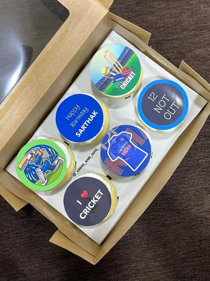 Customized cupcakes for a cricket fan, featuring edible prints of the Indian cricket jersey, players, and fun slogans.