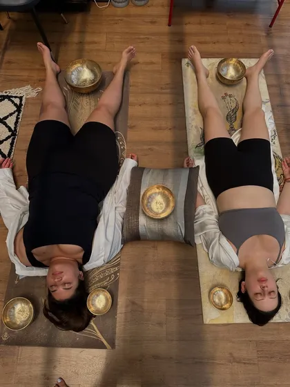 Another view of a couples sound bath, showing the symmetrical arrangement of the bowls. This setup helps to balance the energy field between two people, making it a powerful session for partners or friends.