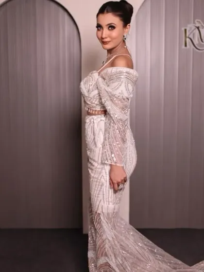 A side view of the white and silver gown, showing its elegant silhouette.