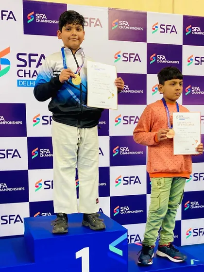 A close-up of Yuvaan Kumar with his well-earned gold medal and certificate at the SFA Championship.
