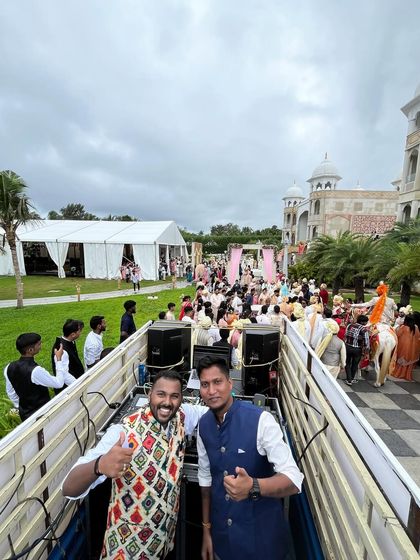 A great shot with my partner from the top of our Baraat on Wheels setup, with the entire wedding procession stretching out behind us.