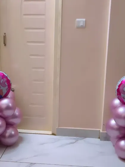A close-up of the balloon pillars with "Baby Girl" foil balloons, a simple and charming addition to any newborn welcome decoration.