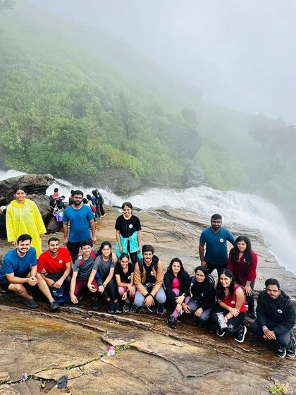 Another happy group posing at the edge of the falls. We make sure everyone gets their hero shot after a long day of trekking.