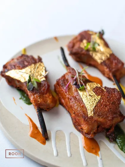 Our Golden Vark Lamb Chops, beautifully arranged. The tender, spiced lamb is elevated by the touch of gold, making it a luxurious centerpiece of our menu.