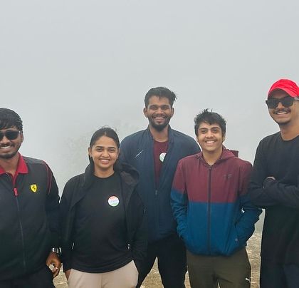 A small group of friends enjoying the misty morning at the top of Skandagiri.