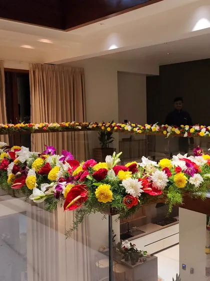 A beautiful floral decoration for a glass railing inside a house. The colorful flowers add a festive touch to the entire space.