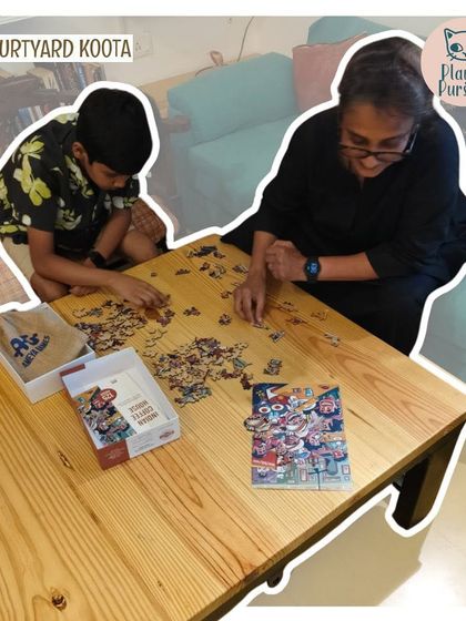 A grandmother and grandson puzzling together, a heartwarming moment from our Jigsaw Jam.