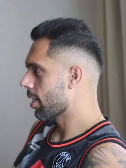 A side profile view of a high fade haircut for my friend Robin Singh. This shot highlights the precise blending and sharp lines that are crucial for a modern athletic hairstyle. I am happy to be back on the road providing these pre-season trims.