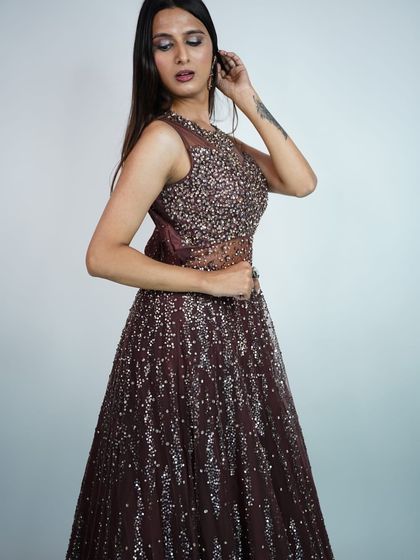 A three-quarter view that captures the elegant silhouette and shimmering texture of this stunning rental gown.