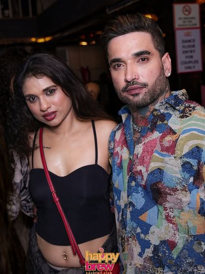 A stylish couple at the anniversary party.