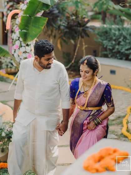 Walking hand-in-hand into their future. This shot captures the couple in their beautiful South Indian wedding attire, full of anticipation and happiness.