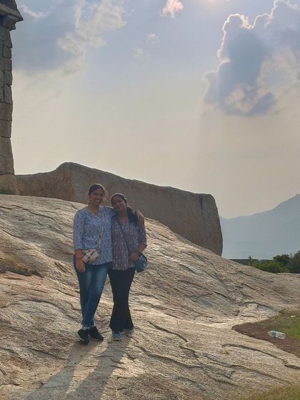 A photo of two friends at the summit, a memory of a shared accomplishment.